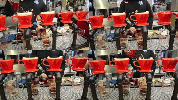 咖啡师在泰国曼谷邦纳-特拉德路百货公司的咖啡角将热水倒入新鲜的咖啡粉中