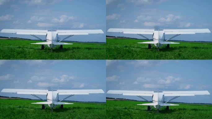 小飞机启动发动机站在乡村绿野晴天