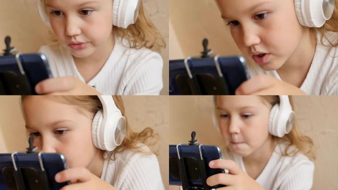 一个可爱的十几岁的女孩正在使用电话并戴着耳机进行视频通话。在线教育基础和附加。使用互联网进行远程学习