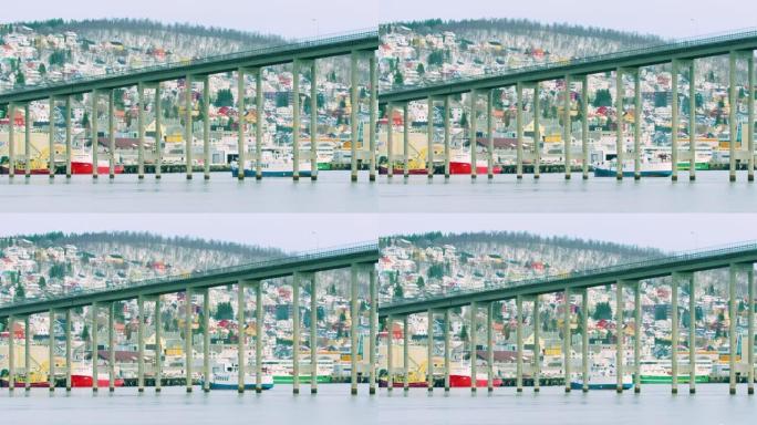 特罗姆瑟桥的低空镜头和一艘船在其下方经过