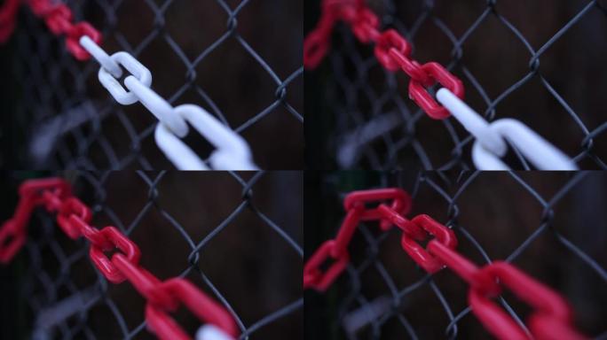 红白弱塑料链附在铁丝网上