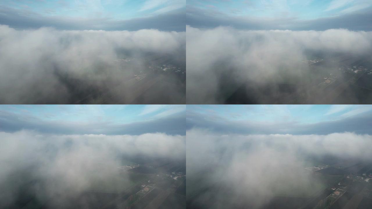 在低空的云层中飞行。从飞机驾驶舱看，滑翔机。