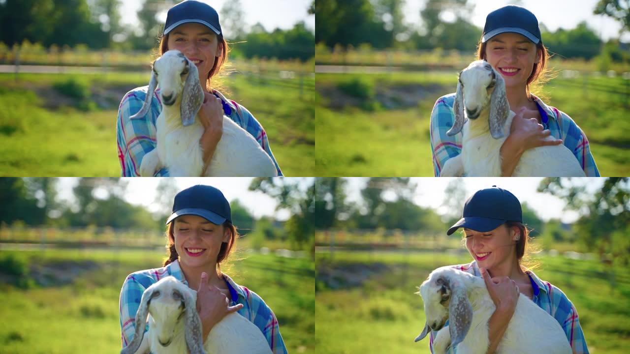 农场的女访客抱着小波尔山羊，养牛场的生态旅游