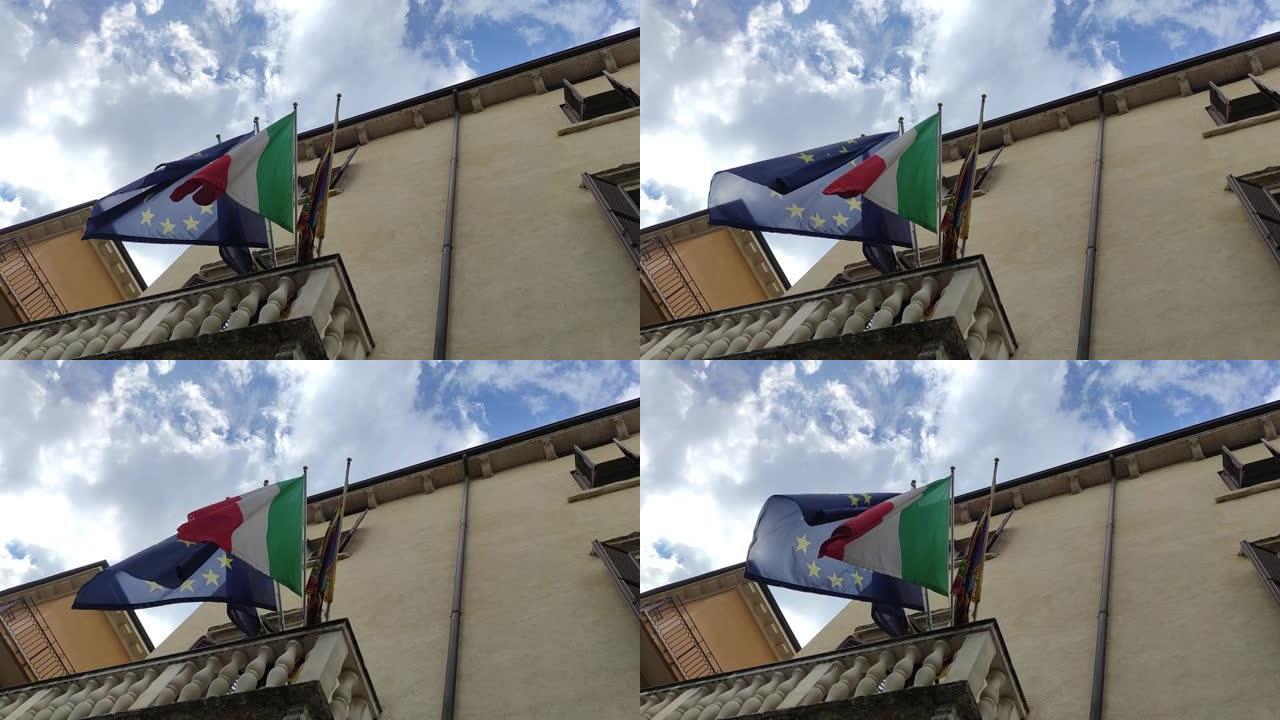 欧洲和意大利一起在意大利建设欧盟。在蓝天上挥舞着意大利和欧洲联盟国旗的织物纹理。