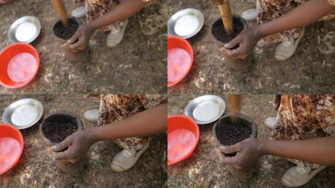 在埃塞俄比亚，一名妇女在杵中研磨并压碎煮熟的咖啡