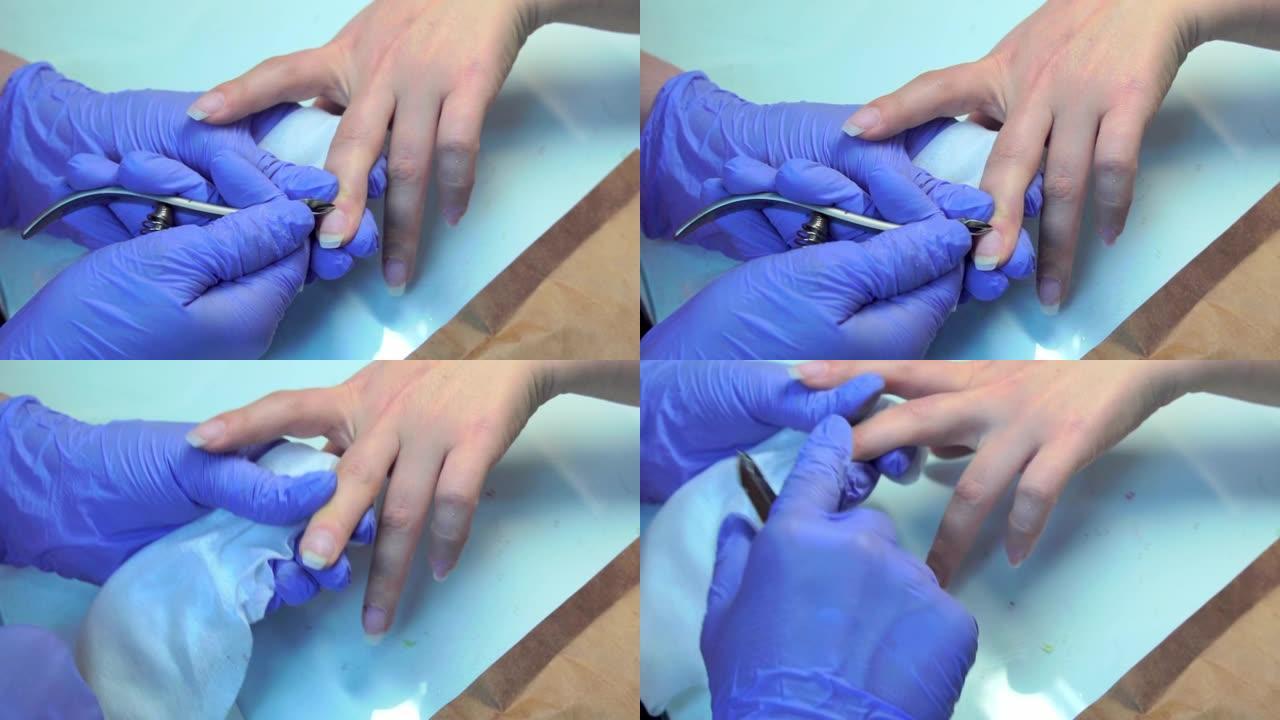 修指甲大师对女人做修指甲的特写，切掉角质层