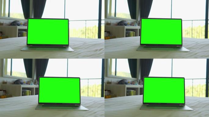 笔记本电脑在家里的床上显示绿屏。