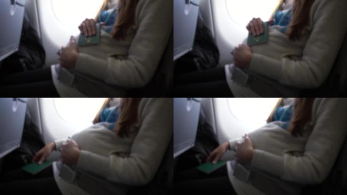 散焦射击孕妇手里拿着护照。国际旅行
