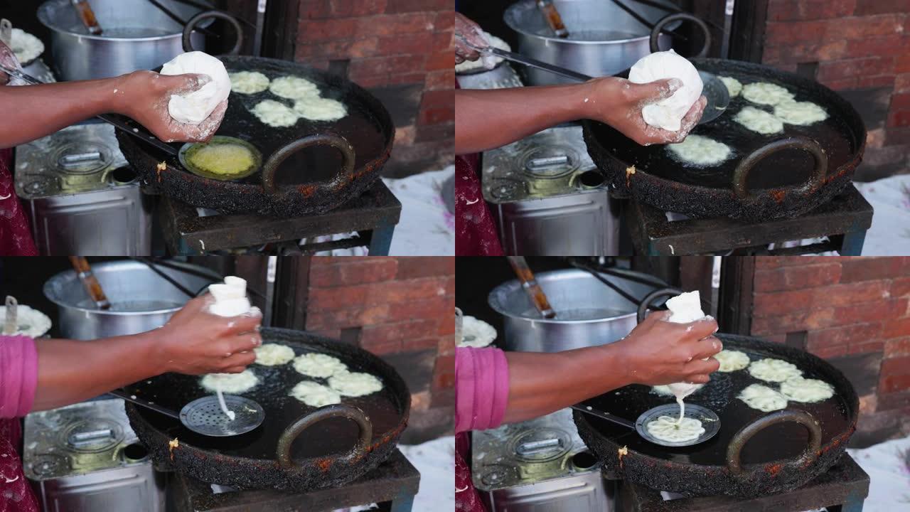尼泊尔街头小贩准备甜食 (jalebi)，巴克塔普尔