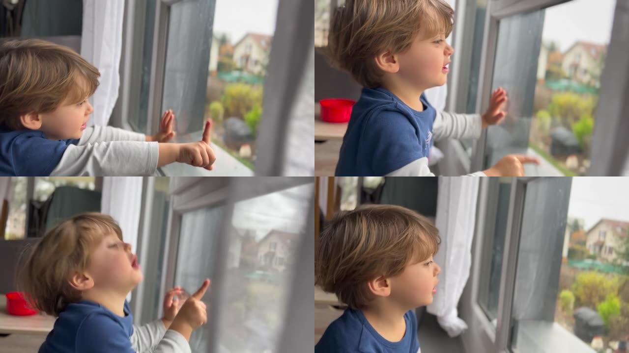 孩子坐在窗边被困在家里。小男孩想出门在外
