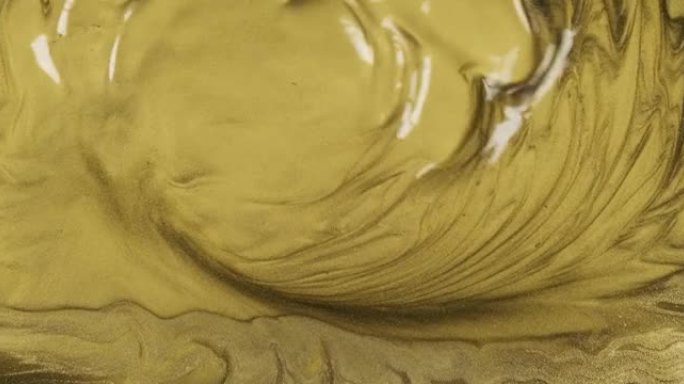 波浪形金色抽象液体背景。液体黄金抽象背景。风流吹走金漆。美丽的金属黄色纹理。金波背景。金色纹理