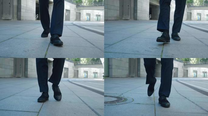 前视图的商人脚穿着黑色的鞋子和正式的衣服走在户外，做台阶，通勤上班，steadicam拍摄。