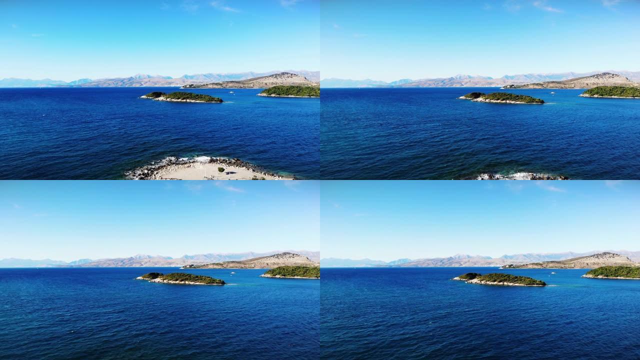 飞越带岛屿的蓝色景观海滨离子海边，旅游假日空中拍摄，蓝色的水，阳光明媚的日子，阿尔巴尼亚ksamil
