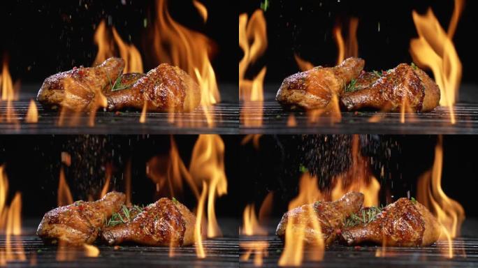 鸡腿或鸡腿在热烧烤木炭火焰烤架上烤，上面撒上香料。在烧烤烤架上烤多汁的鸡肉。慢动作