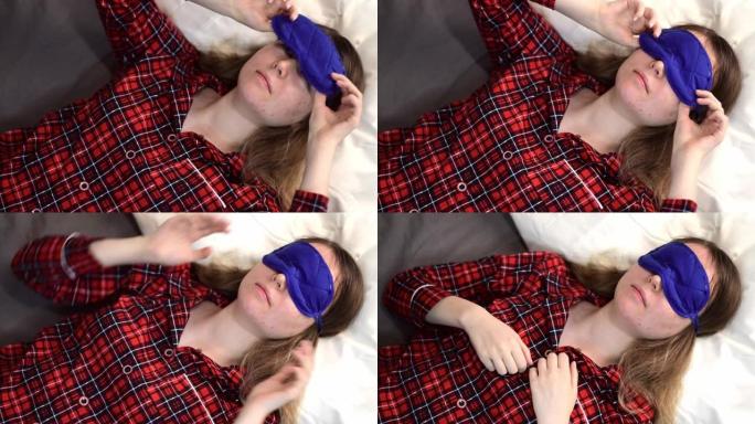 年轻女子戴上蓝色睡眠面具