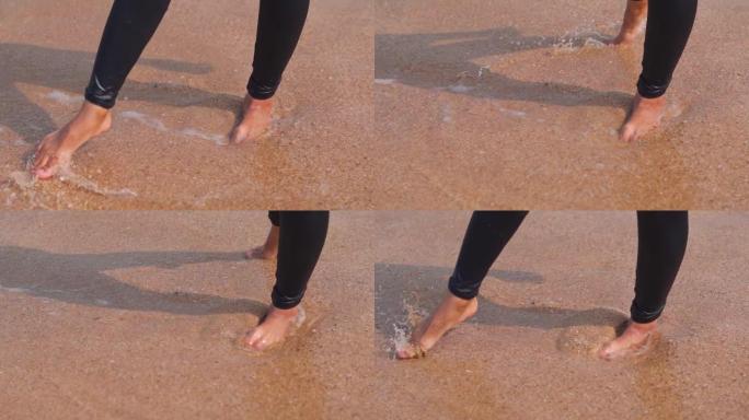 无忧无虑的印度女性在海滩上泼水的腿的特写镜头。暑假在热带海滩玩耍的女人。休闲活动