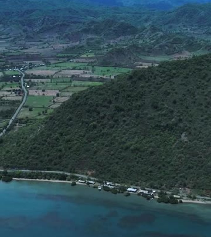 带有养虾场，小山丘和浅礁的热带岛屿的空中拍摄的垂直视频