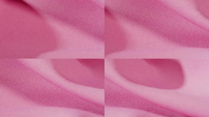 粉色面料特写，缎面奢华布料纹理背景。豪华设计纺织品