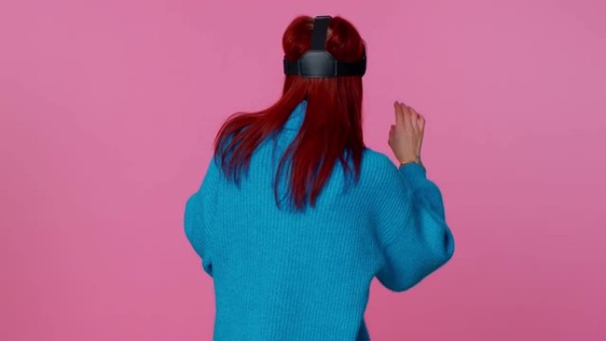 女孩使用虚拟现实未来技术VR耳机头盔玩模拟3D视频游戏
