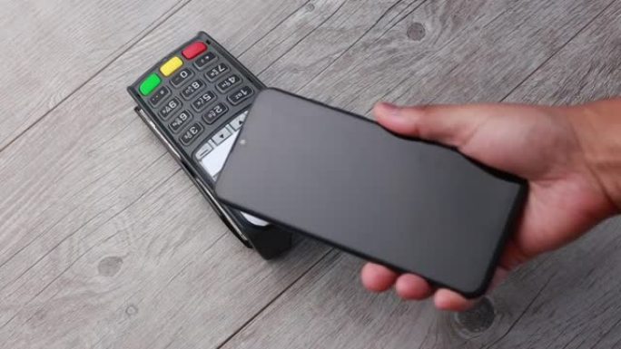 移动NFC支付。用NFC技术通过pos终端用手机支付的客户之手。电话无线支付系统