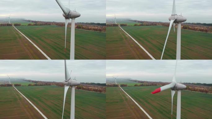 风力涡轮机农场生态场。野外风车上方的日出。鸟瞰图。能源生产。在美丽的日落秋景上旋转风力涡轮机。绿色生