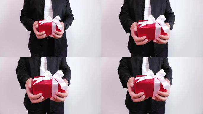黑衣人手持红色礼品盒并赠送的特写镜头。