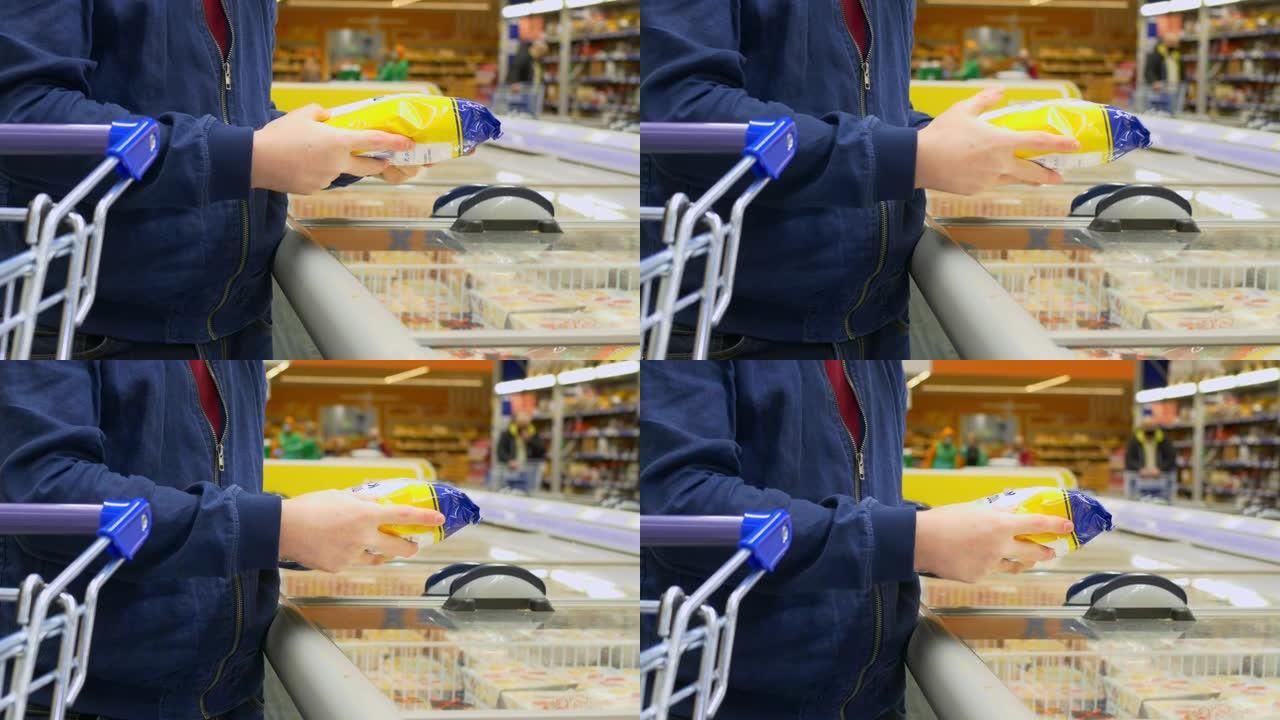 一名男子在杂货店购买冷冻半成品，他选择了冷冻产品，在购买前阅读成分。杂货店里的男人