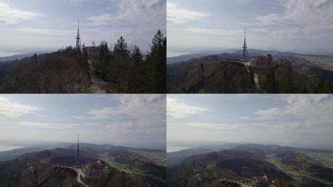 在蓝色阴天的春天，鸟瞰图形成了当地的Uetliberg山，风景秀丽，背景是山脉。