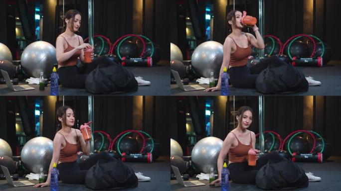 亚洲美女在健身房锻炼后制作，shanking和喝蛋白质奶昔，肌肉获得营养，健康