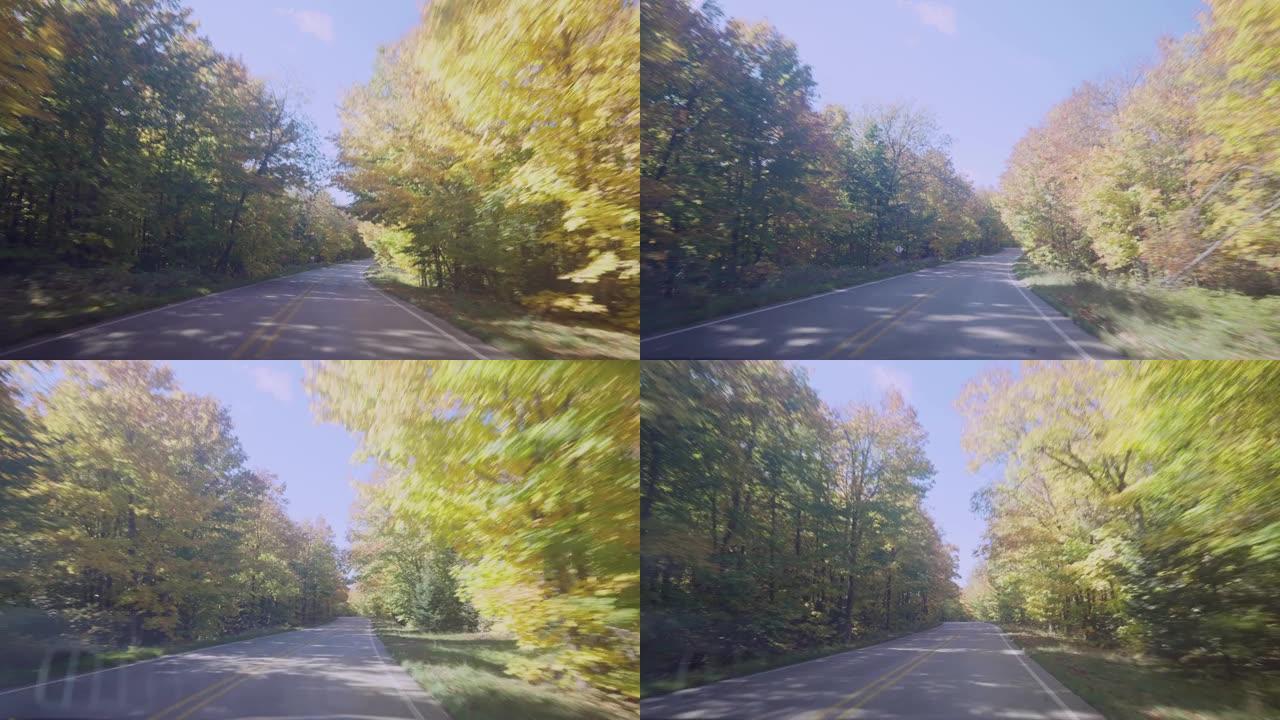 沿着弯曲的秋季森林路行驶