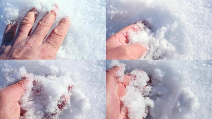 特写一只人手摸雪，一只手玩雪，摸雪，