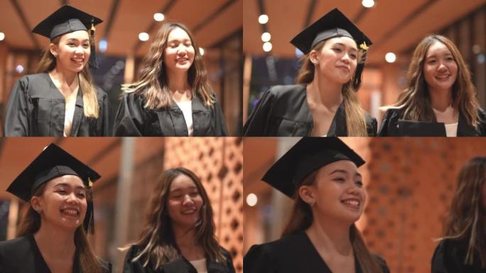亚洲十几岁的女孩穿着毕业礼服布带着心情开心。穿黑色毕业礼服的人持有毕业证书。