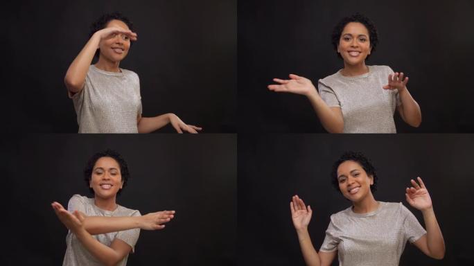 快乐的年轻女子在黑色背景上跳舞