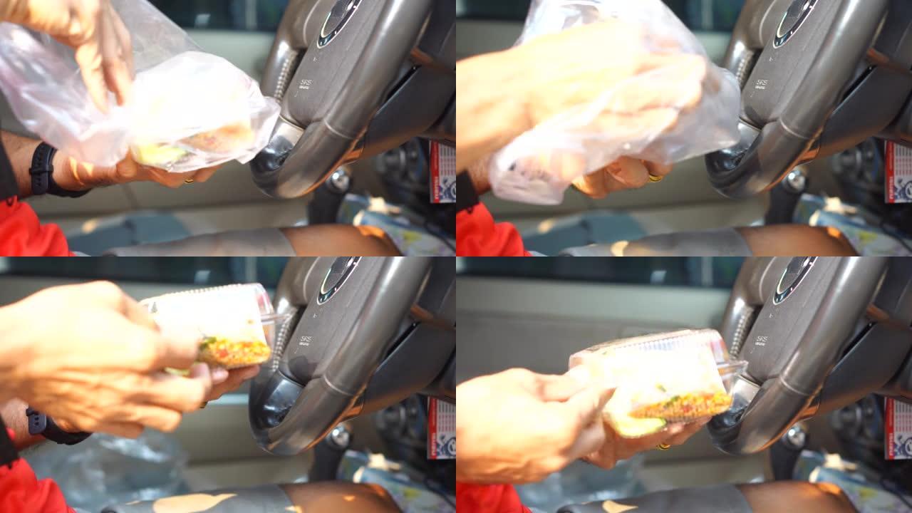 在车里吃盒饭的男人用煎蛋炒罗勒
