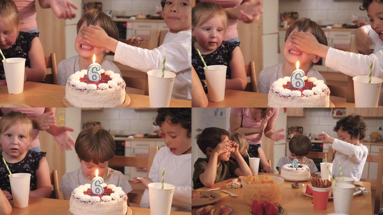 男孩用歌声吹着生日蜡烛，拍着快乐的朋友
