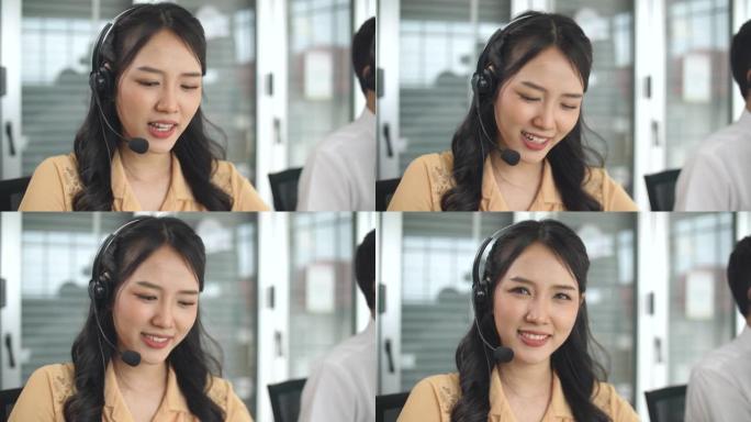 戴着耳机和支持客户，看着相机工作的美丽女性呼叫中心的肖像照片