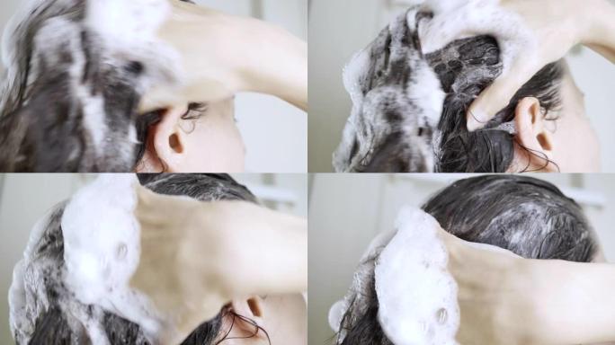黑发年轻女子洗头用洗发水泡沫特写