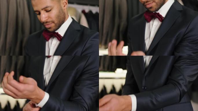 相机特写镜头在豪华西装店的美国黑人客户试图穿黑色西装的设计时装和商业概念。4k
