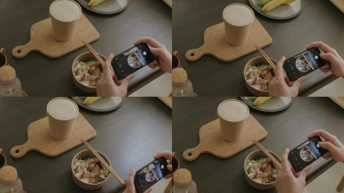 不明身份的人用智能手机给他的午餐拍照。