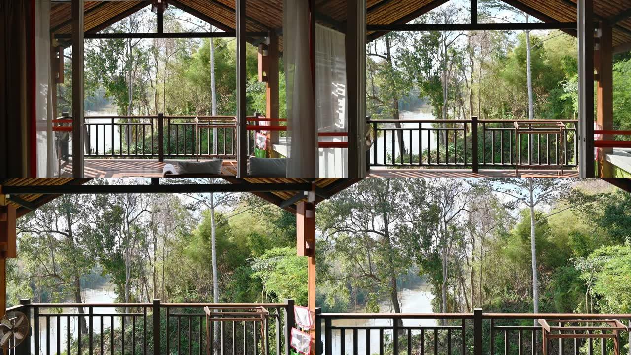 度假胜地的卧室内部，带阳台和热带雨林景观