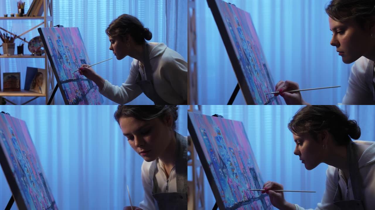 艺术家在创意工作室的画布上绘画。年轻女子用画笔和调色板上的油画创作绘画。拥有高层建筑和蓝色调桥梁的城