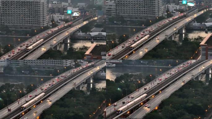 空中无人机在曼谷的超披亚河上的高速公路和地铁天空列车上的交通车灯的日出场景