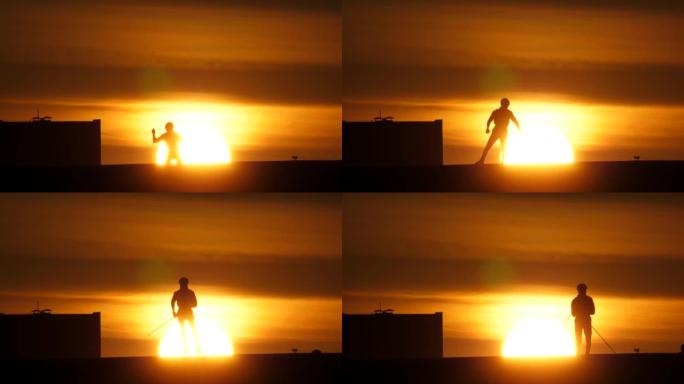 夏季男子在rollerskis上训练，在日落的阳光下拍摄剪影