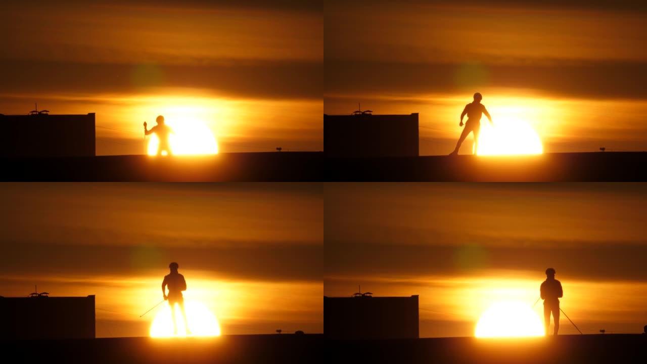 夏季男子在rollerskis上训练，在日落的阳光下拍摄剪影