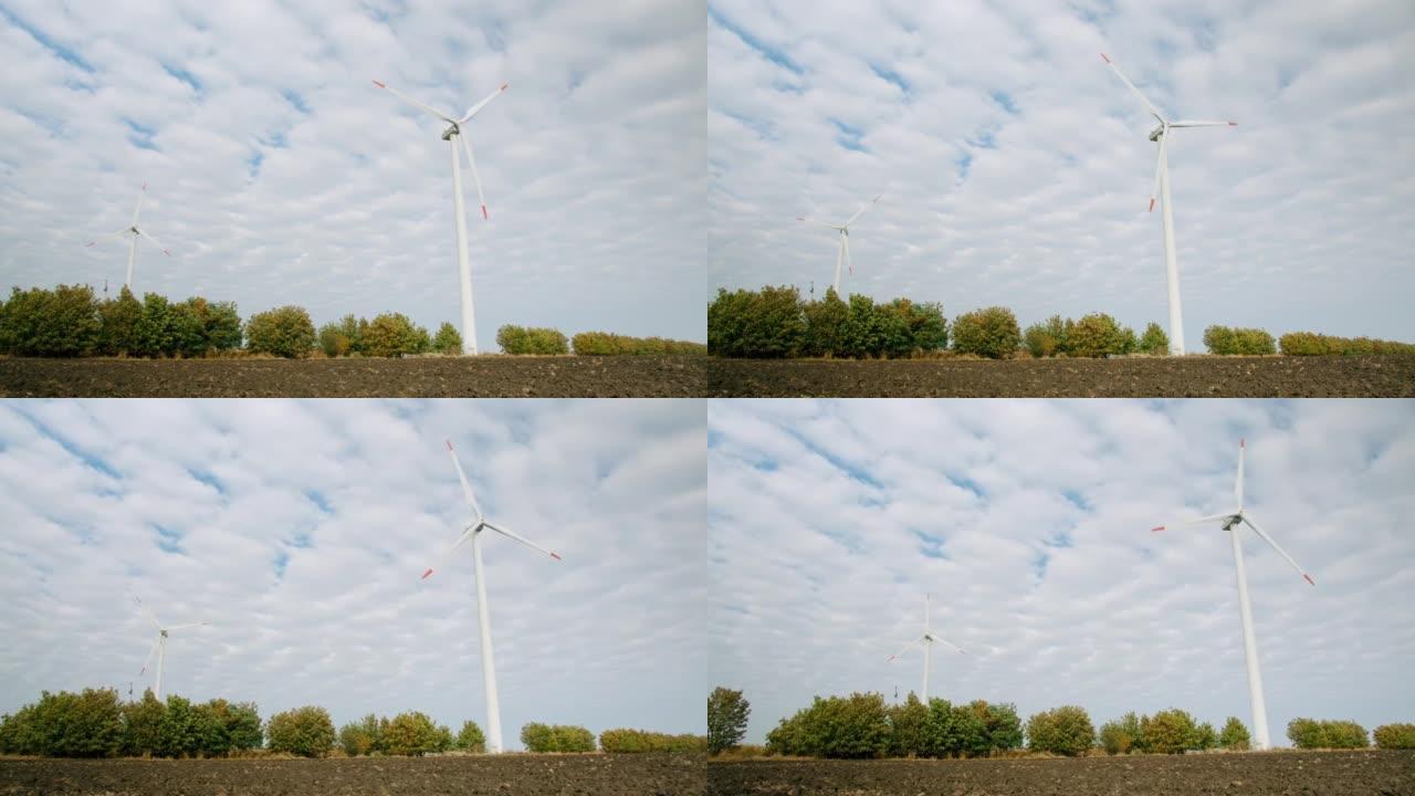 风车的风力涡轮机在耕地，发电站中工作