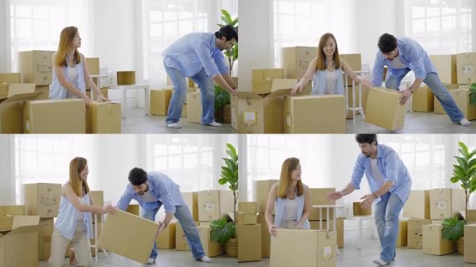 幸福的年轻夫妇打包纸箱，准备搬到新家或公寓。美丽的年轻女子打包纸箱，开心地微笑着，而她的丈夫拿着纸箱