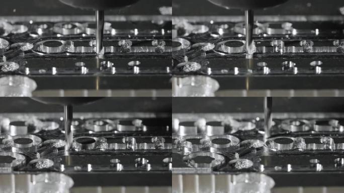 金属加工铣床。钻钢，慢动作。钻孔机加工金属，切出形状。现代细节加工技术。关闭工业细节