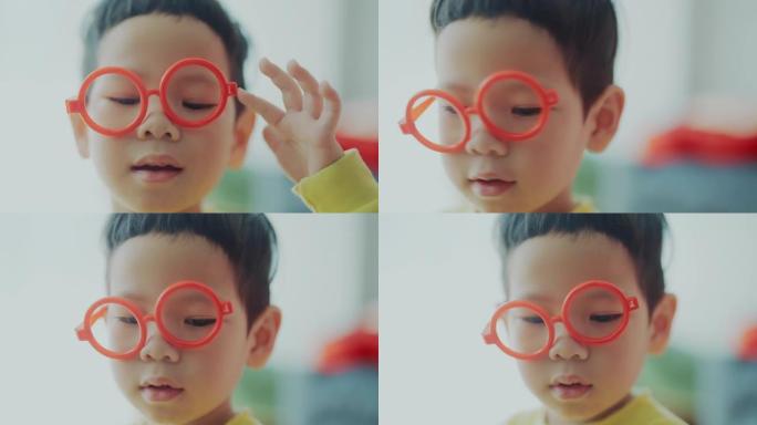 2-3岁可爱的男孩保护眼睛免受蓝光照射。