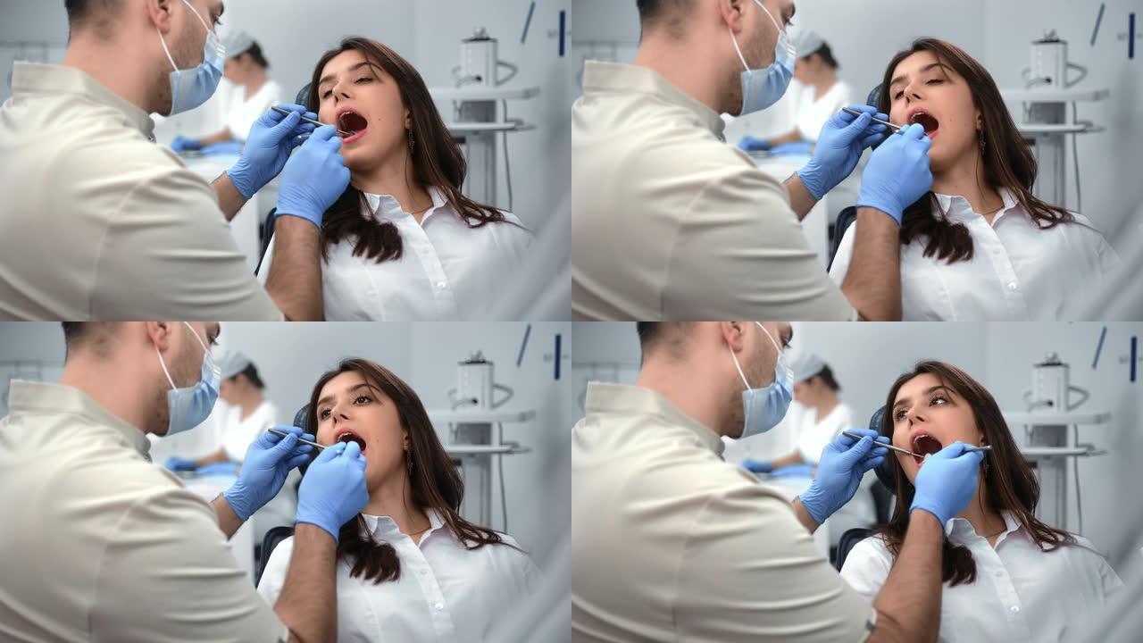 在诊所定期进行牙科体检时张口的女性患者
