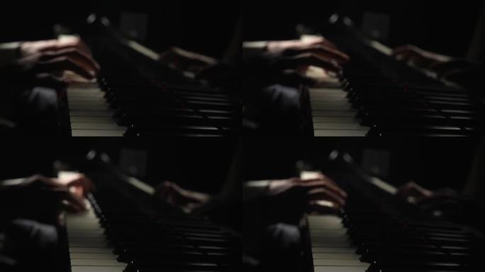 才华横溢的钢琴家在黑暗中用钢琴演奏古典旋律。人的手模糊的镜头触摸弦乐器的键。音乐艺术家的表演。特写。